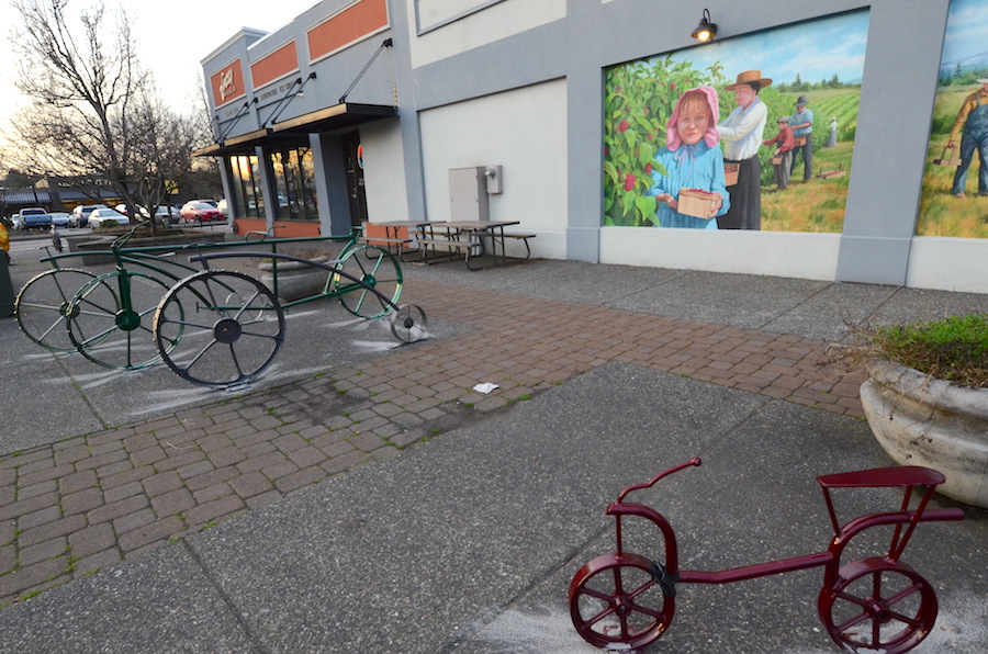 Bike farm racks in front of farm mural.