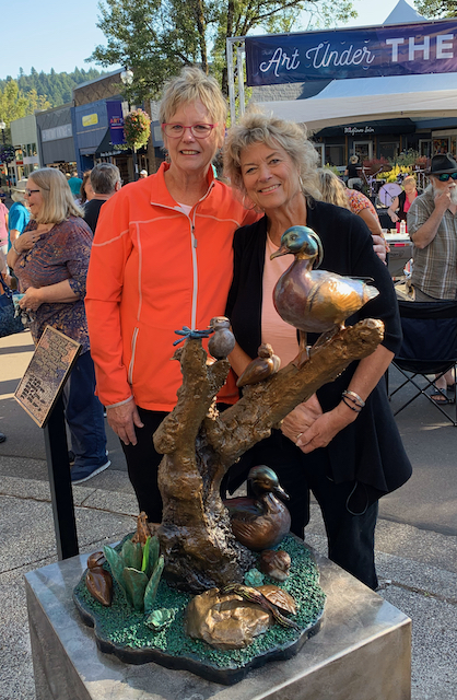 Judy and Lynn with Bless Our Nest statue