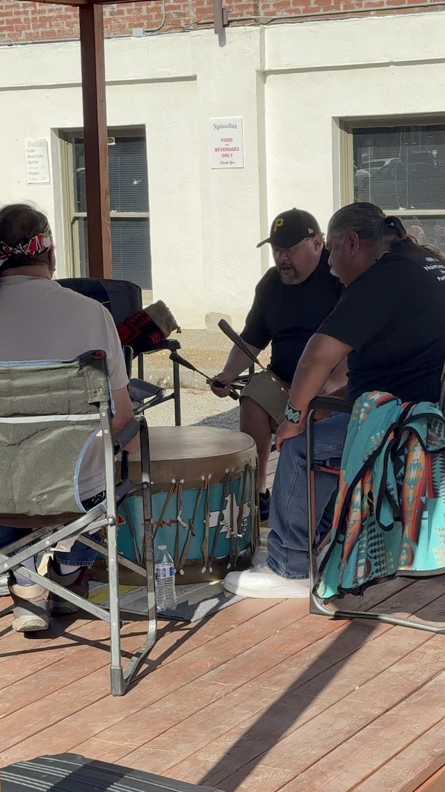 Native drummers drumming on stage.