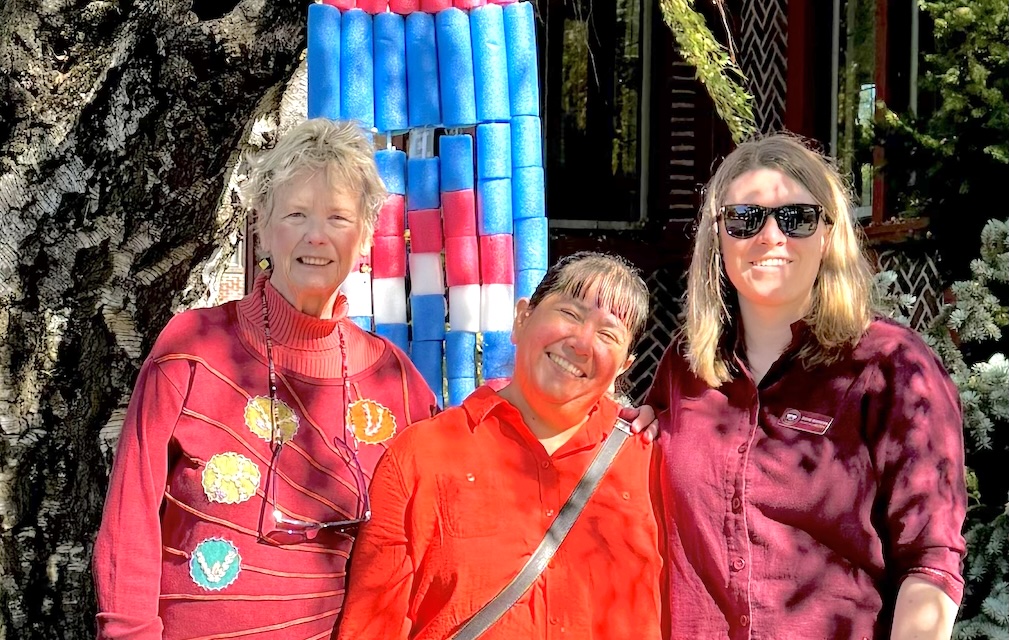 Three women standing outside the museum